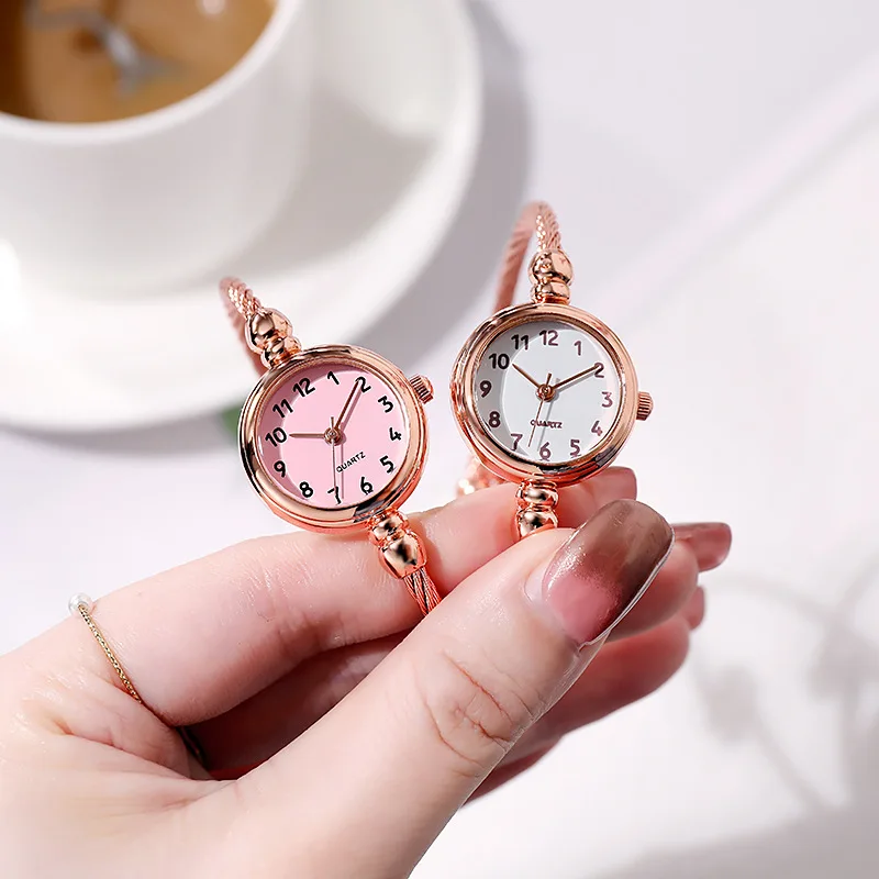A Hand Holding A Couple Of Clocks