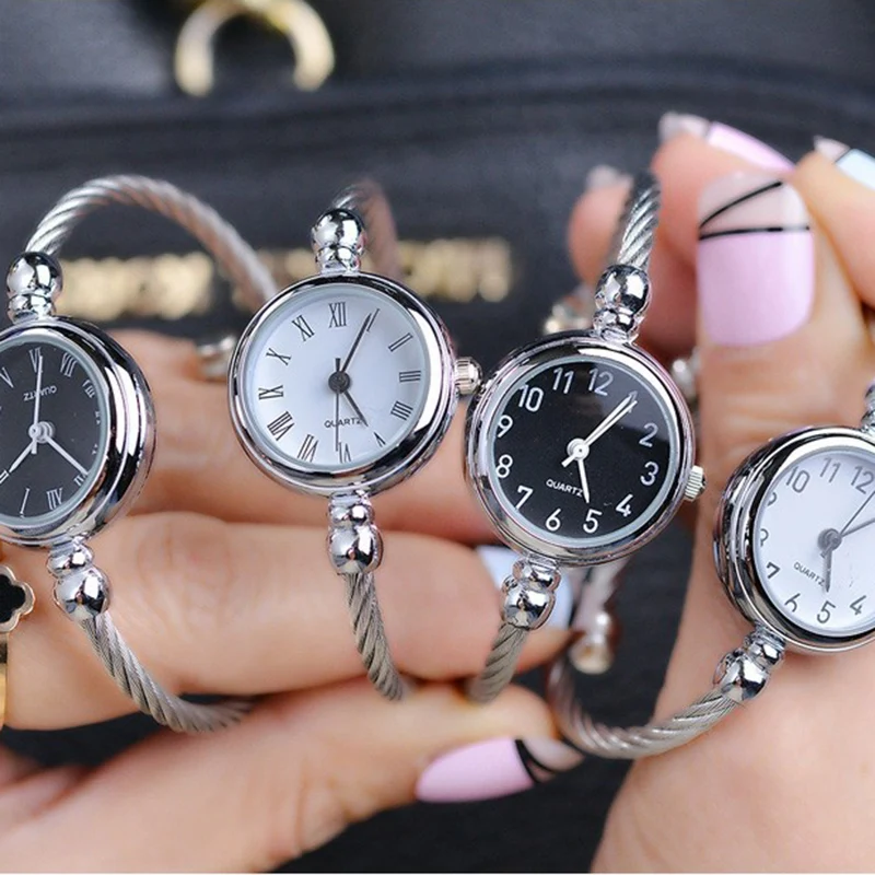 A Hand Holding A Group Of Watches