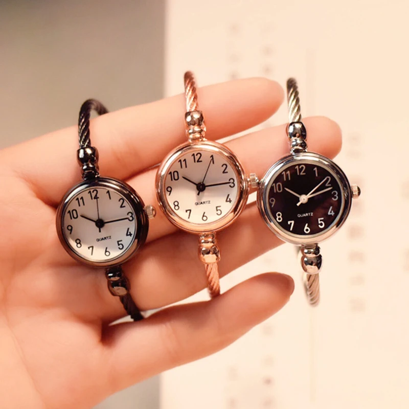 A Hand Holding A Group Of Watches