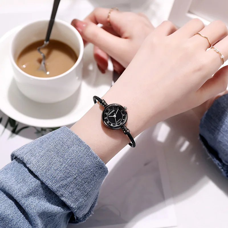 A Person Wearing A Watch And A Cup Of Coffee