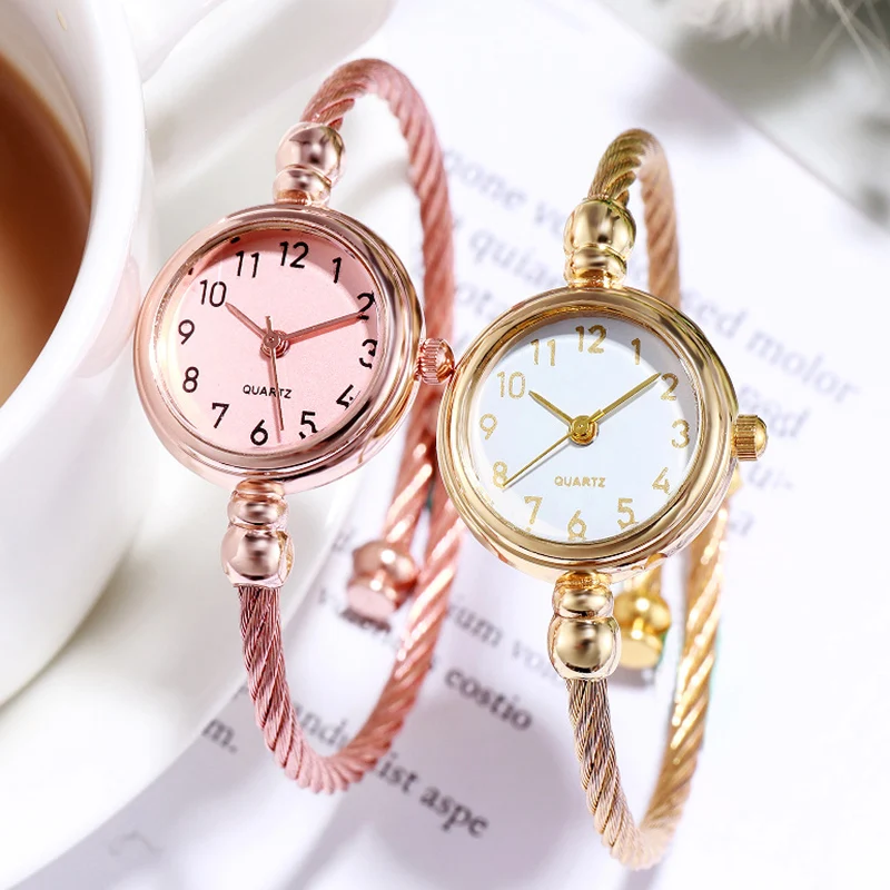 A Couple Of Gold And Pink Wrist Watches
